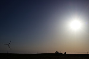 A lone wind turbine spins in the breeze on the Ferrell Ranch near Beaumont, Kan. shortly after sunrise on June 13, 2014. (Kevin Brown/Flint Hills Media Project)